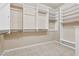 Spacious walk-in closet featuring custom shelving, ample storage, and neutral carpeting at 4042 Keefe Falls Ct, North Las Vegas, NV 89085