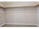 Spacious walk-in closet with upper shelving, wooden rail, and neutral carpeting at 4042 Keefe Falls Ct, North Las Vegas, NV 89085