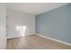 Bright bedroom with blue accent wall, wood flooring, and closet at 4310 Sandy River Dr # 70, Las Vegas, NV 89103