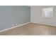 Bright bedroom with blue accent wall, wood flooring, and natural light at 4310 Sandy River Dr # 70, Las Vegas, NV 89103