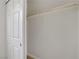 Walk-in closet featuring white walls and wooden rod for organized storage at 4310 Sandy River Dr # 70, Las Vegas, NV 89103