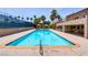 Rectangular community pool with tile trim, seating and palm trees nearby at 4310 Sandy River Dr # 70, Las Vegas, NV 89103