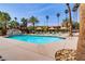 Well-maintained community pool with lounge seating, cabanas, rock feature, and mature palm trees at 4310 Sandy River Dr # 70, Las Vegas, NV 89103