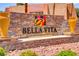 Bella Vita community sign with stone background, landscaping, and decorative yellow vases at 4310 Sandy River Dr # 70, Las Vegas, NV 89103