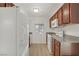 Cozy kitchen featuring white appliances, wood cabinets and granite countertops at 4310 Sandy River Dr # 70, Las Vegas, NV 89103