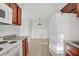 Bright kitchen with white appliances, wood cabinets, and light wood flooring at 4310 Sandy River Dr # 70, Las Vegas, NV 89103