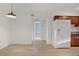 Bright kitchen with white appliances, warm wood cabinets, and modern light fixture at 4310 Sandy River Dr # 70, Las Vegas, NV 89103