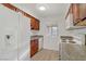 Cozy kitchen featuring white appliances, wood cabinets and granite countertops at 4310 Sandy River Dr # 70, Las Vegas, NV 89103