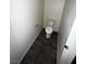 A compact half bathroom featuring a toilet with modern gray wood floors at 4645 Fuchsia Nights Ave # 103, North Las Vegas, NV 89084