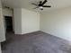 Spacious carpeted bedroom with neutral walls, ceiling fan, and natural lighting at 4645 Fuchsia Nights Ave # 103, North Las Vegas, NV 89084