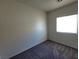 Bedroom with gray carpet and a window with blinds at 4645 Fuchsia Nights Ave # 103, North Las Vegas, NV 89084