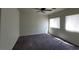 Spacious bedroom with modern ceiling fan, carpet, and two windows providing natural light at 4645 Fuchsia Nights Ave # 103, North Las Vegas, NV 89084