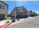 Street view of a two-story townhouse with a three-car garage and balcony on the second level at 4645 Fuchsia Nights Ave # 103, North Las Vegas, NV 89084
