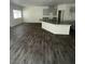 Spacious living room featuring wood floors, with kitchen island with gray cabinets at 4645 Fuchsia Nights Ave # 103, North Las Vegas, NV 89084