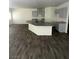 Bright living room featuring wood floors, with kitchen island with gray cabinets at 4645 Fuchsia Nights Ave # 103, North Las Vegas, NV 89084