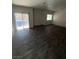 Spacious living room features wood floors, sliding glass door, and natural light at 4645 Fuchsia Nights Ave # 103, North Las Vegas, NV 89084