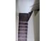 Carpeted stairs lead to the upper or lower level at 4645 Fuchsia Nights Ave # 103, North Las Vegas, NV 89084