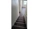 Carpeted staircase in the home with natural light at 4645 Fuchsia Nights Ave # 103, North Las Vegas, NV 89084