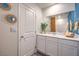 Well-lit bathroom featuring a white vanity with ample storage and a decorative mirror at 4839 Orchid Ridge Ave # 96, Las Vegas, NV 89141