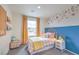 Bedroom with a blue accent wall and cute decor at 4839 Orchid Ridge Ave # 96, Las Vegas, NV 89141