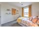 Bedroom featuring pastel decor, wall shelves, and a window at 4839 Orchid Ridge Ave # 96, Las Vegas, NV 89141