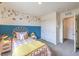Cozy bedroom featuring a decorative headboard, accent wall, and closet with sliding doors at 4839 Orchid Ridge Ave # 96, Las Vegas, NV 89141