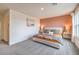 Bright bedroom with modern decor, gray carpet, and a warm accent wall at 4839 Orchid Ridge Ave # 96, Las Vegas, NV 89141