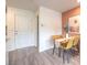 Cozy dining area with modern table, and a painting on the neutral salmon colored wall at 4839 Orchid Ridge Ave # 96, Las Vegas, NV 89141