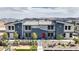 New two-story townhome with blue and gray accents, a red door, and desert landscaping at 4839 Orchid Ridge Ave # 96, Las Vegas, NV 89141