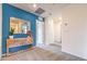 Upstairs hallway with blue accent wall and wooden cabinet at 4839 Orchid Ridge Ave # 96, Las Vegas, NV 89141