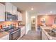 The kitchen features stainless steel appliances, including a microwave and stove, plus white cabinets and gray countertops at 4839 Orchid Ridge Ave # 96, Las Vegas, NV 89141