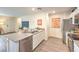 Open kitchen boasts stainless steel appliances, gray countertops, white cabinets, and wood-look flooring at 4839 Orchid Ridge Ave # 96, Las Vegas, NV 89141