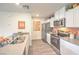 Bright kitchen features stainless steel appliances, gray countertops, white cabinets, and wood-look flooring at 4839 Orchid Ridge Ave # 96, Las Vegas, NV 89141