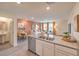 Open concept room with view of kitchen with stainless steel appliances and white cabinets and view of living room and dining room at 4839 Orchid Ridge Ave # 96, Las Vegas, NV 89141
