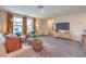 Living room featuring neutral colors, wood floors, and a large window for natural light at 4839 Orchid Ridge Ave # 96, Las Vegas, NV 89141