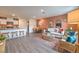 Open-concept living area with kitchen, dining, and stylish furniture, wood floors, and neutral tones at 4839 Orchid Ridge Ave # 96, Las Vegas, NV 89141