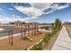 Community playground with climbing structures, a slide, and seating areas for residents at 4839 Orchid Ridge Ave # 96, Las Vegas, NV 89141