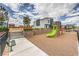 Community playground with colorful equipment, a green slide, and nearby seating area at 4839 Orchid Ridge Ave # 96, Las Vegas, NV 89141