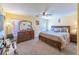 Spacious bedroom with a ceiling fan, dresser, and a comfortable bed with decorative pillows at 5017 Hadley Meadow Ct, Las Vegas, NV 89131