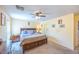 Bedroom with neutral walls, ceiling fan, and a comfortable bed, complemented by side tables and warm lighting at 5017 Hadley Meadow Ct, Las Vegas, NV 89131