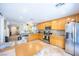 Well-lit kitchen featuring stainless steel appliances, a functional layout, and tile flooring at 5017 Hadley Meadow Ct, Las Vegas, NV 89131