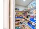 Walk-in pantry with white shelving provides ample storage space for food and kitchen essentials at 5017 Hadley Meadow Ct, Las Vegas, NV 89131