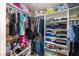 Organized walk-in closet featuring shelves, hanging racks, and designated spaces for clothes and accessories at 5017 Hadley Meadow Ct, Las Vegas, NV 89131