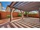Outdoor patio space features a pergola, decorative drapes and brick flooring at 5239 Tartan Hill Ave, Las Vegas, NV 89141