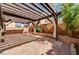 This backyard patio has a brick floor, pergola with lights and an outdoor seating area at 5239 Tartan Hill Ave, Las Vegas, NV 89141