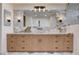 Spa bathroom featuring a double vanity with marble countertops and a large mirror at 5239 Tartan Hill Ave, Las Vegas, NV 89141