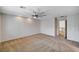 Large bedroom with carpet, ceiling fan, and doorway to bathroom with lots of natural light at 5239 Tartan Hill Ave, Las Vegas, NV 89141
