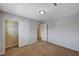 Neutral bedroom features tan carpet, closet and white doors at 5239 Tartan Hill Ave, Las Vegas, NV 89141