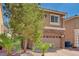Attractive two-story residence featuring a stone-detailed garage, neat desert landscaping, and a welcoming facade at 5239 Tartan Hill Ave, Las Vegas, NV 89141