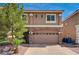 Inviting two-story home showcases a stone-accented garage, desert landscaping, and well-maintained front yard at 5239 Tartan Hill Ave, Las Vegas, NV 89141